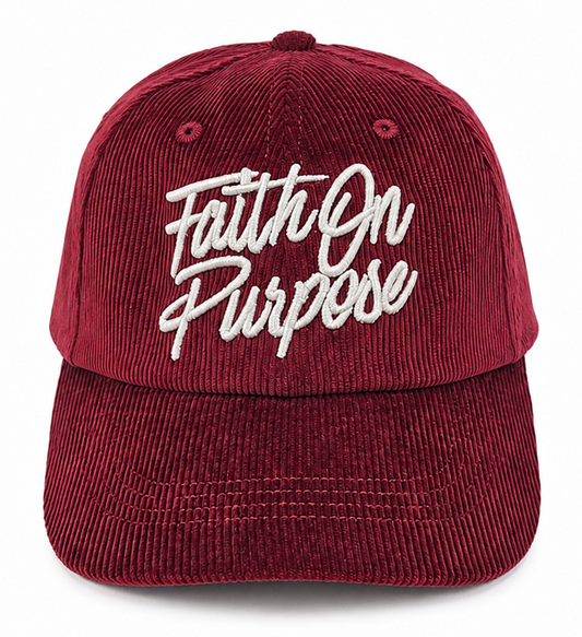 A maroon corduroy baseball cap with 'Faith On Purpose' embroidered in white script across the front, shown against a plain white background.