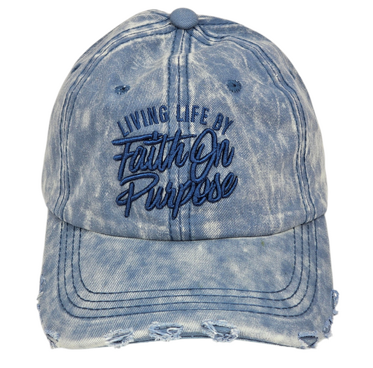 Blue distressed cap with 'Living Life by Faith on Purpose' text on a white background
