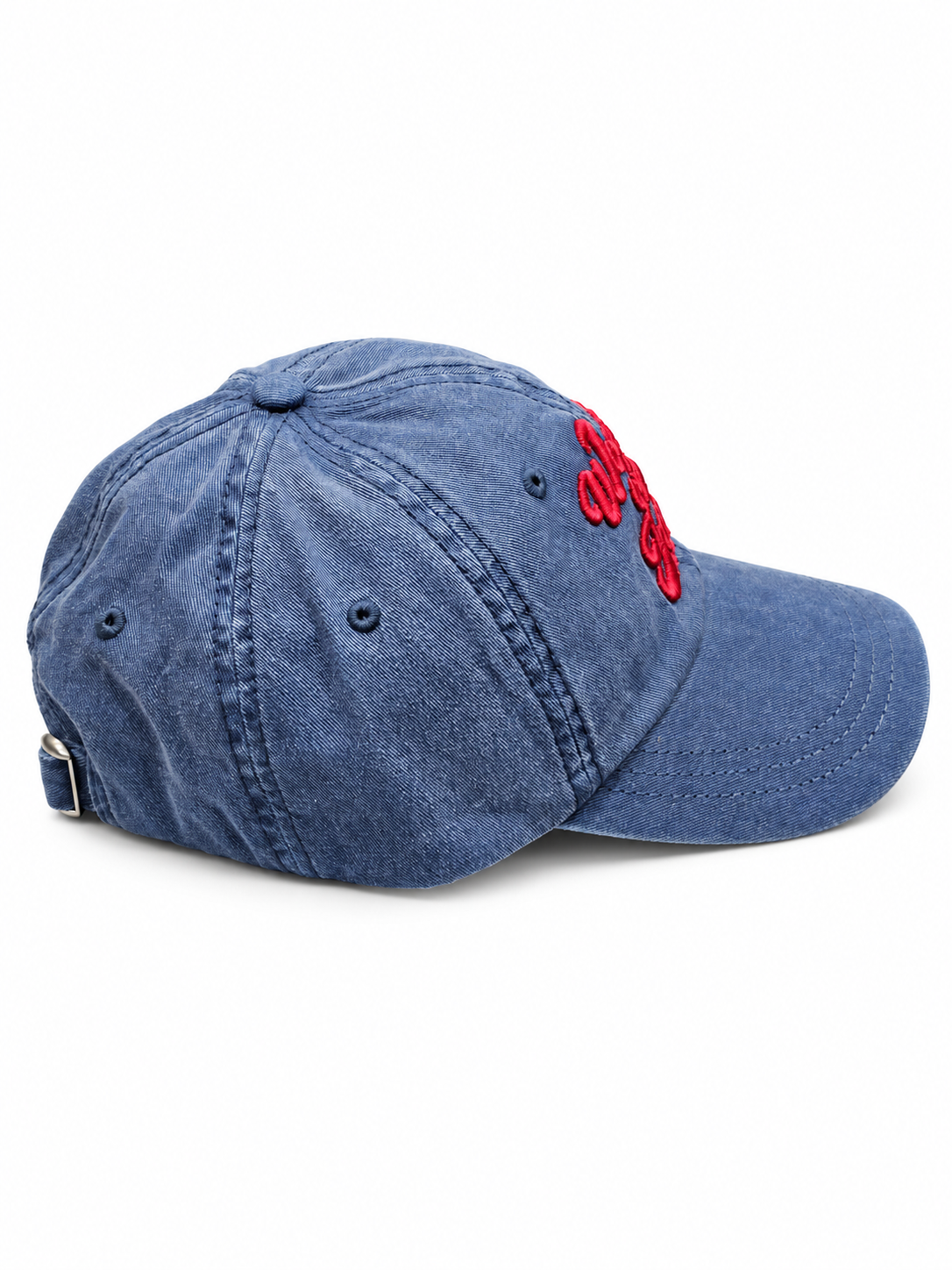A washed blue denim baseball cap with red embroidered lettering on the side, shown against a plain white background.
